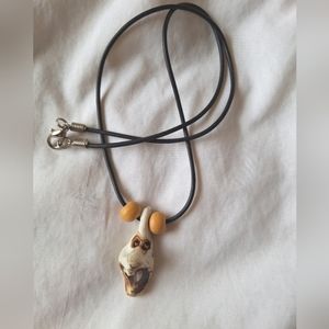 Handmade clay pendant on a 20" leather cord, necklace